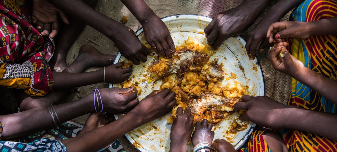 Children eat lunch in a village in Tagal, Chad.